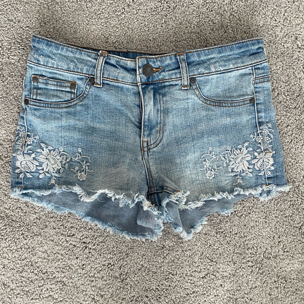 Light wash jean shorts with crochet embellishment